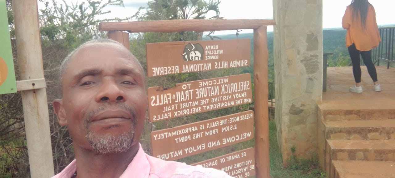 Guide at the Shimba Hills trail sign